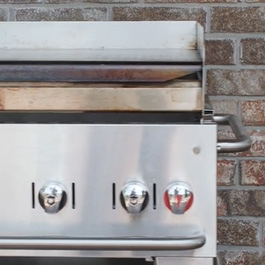 Front view of a stainless steel propane griddle